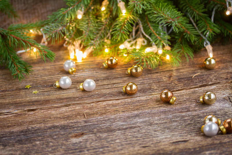 christmas background  - wooden table with defocused lights and glass decorationd